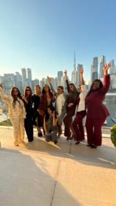Nzoputa with a community of women overlooking a city skyline