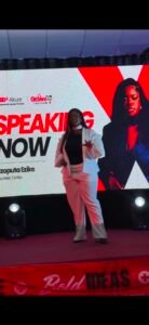 Nzoputa speaking on stage at a professional event